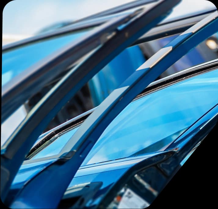 A person touching a car tire and checking its condition precisely